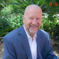 Portrait Ray Merriman sitting in lush garden